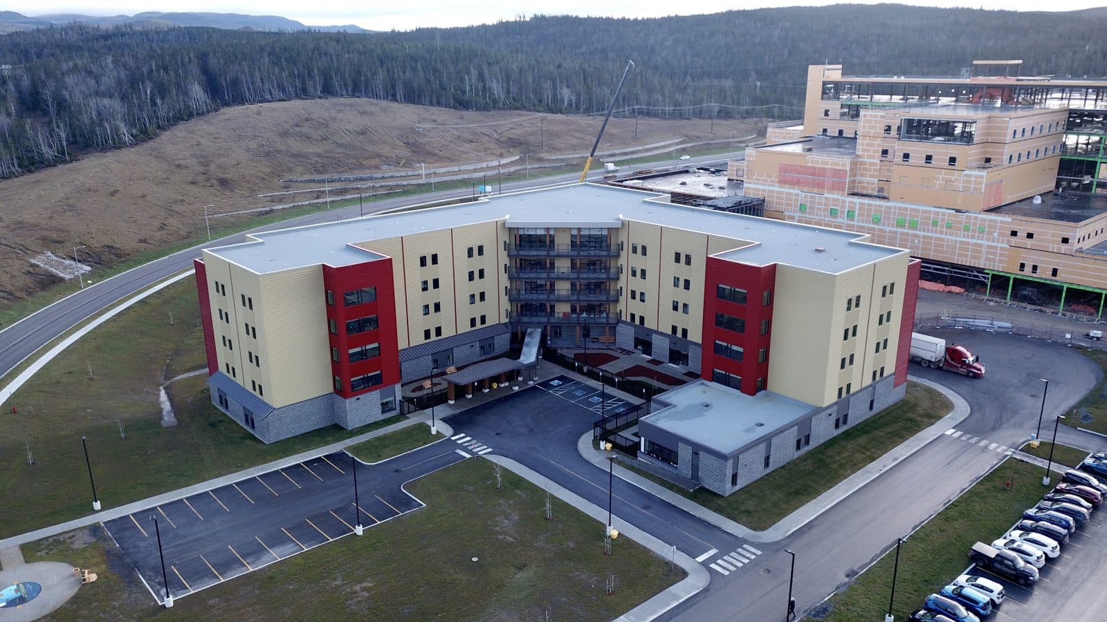 Aerial image of the Corner Brook long-term care facility with a new hospital being built in the background