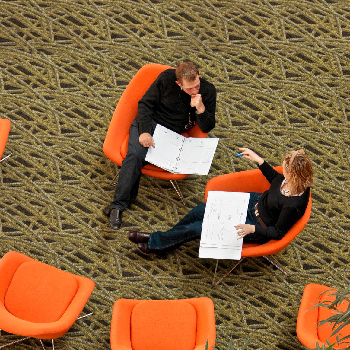 Two infrastructure experts discussing project plans Plenary breakout area