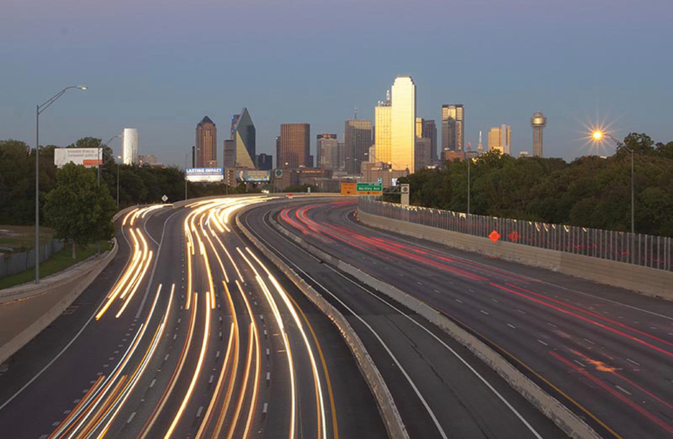 cars driving on a highway in the evening