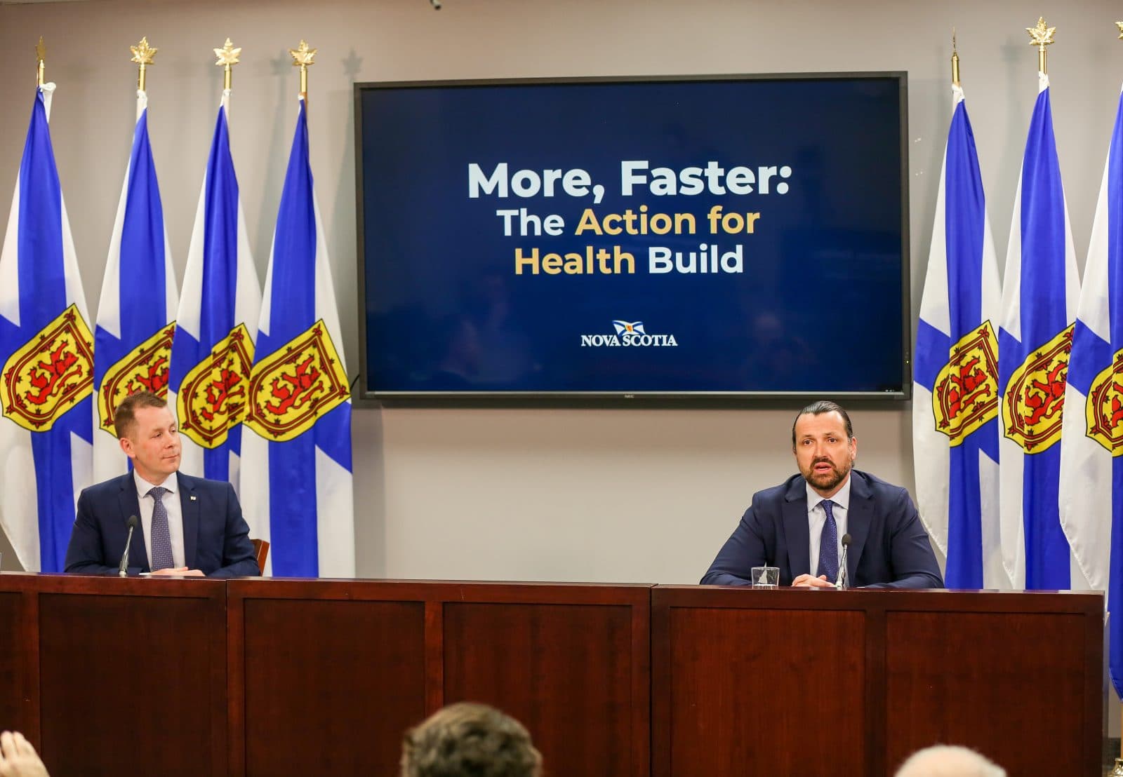 Nova Scotia officials sit at a desk for a press conference